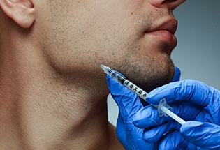 a person injecting BOTOX into a patient’s jaw area