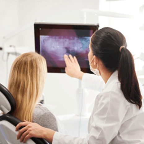 Dentist reviewing dental X-ray with patient
