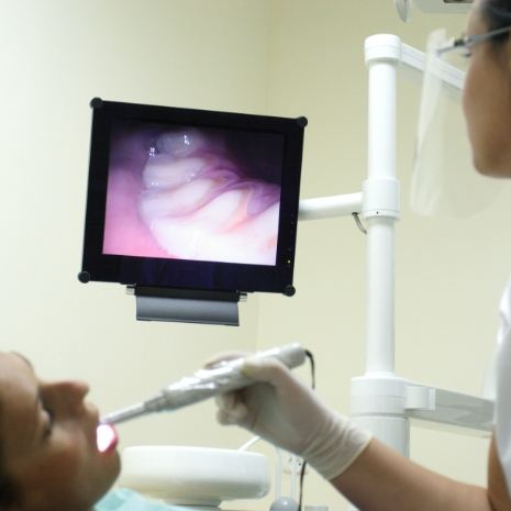 Dentist capturing smile images during dental checkup and teeth cleaning visit