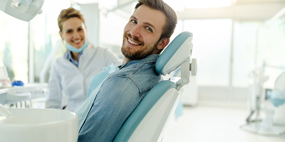 A happy, smiling man sitting in a dentist’s chair