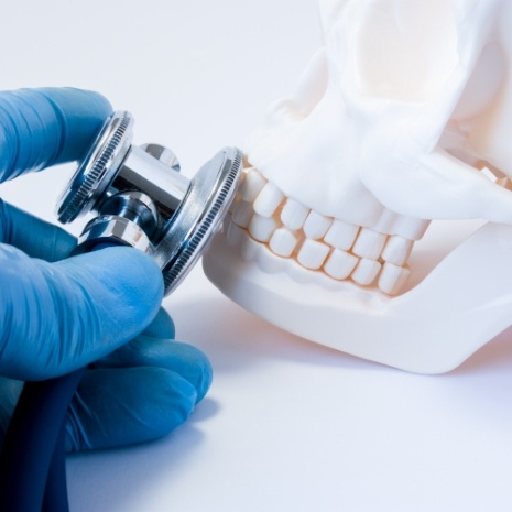 Dentist using smile model to demonstrate cavity detection system
